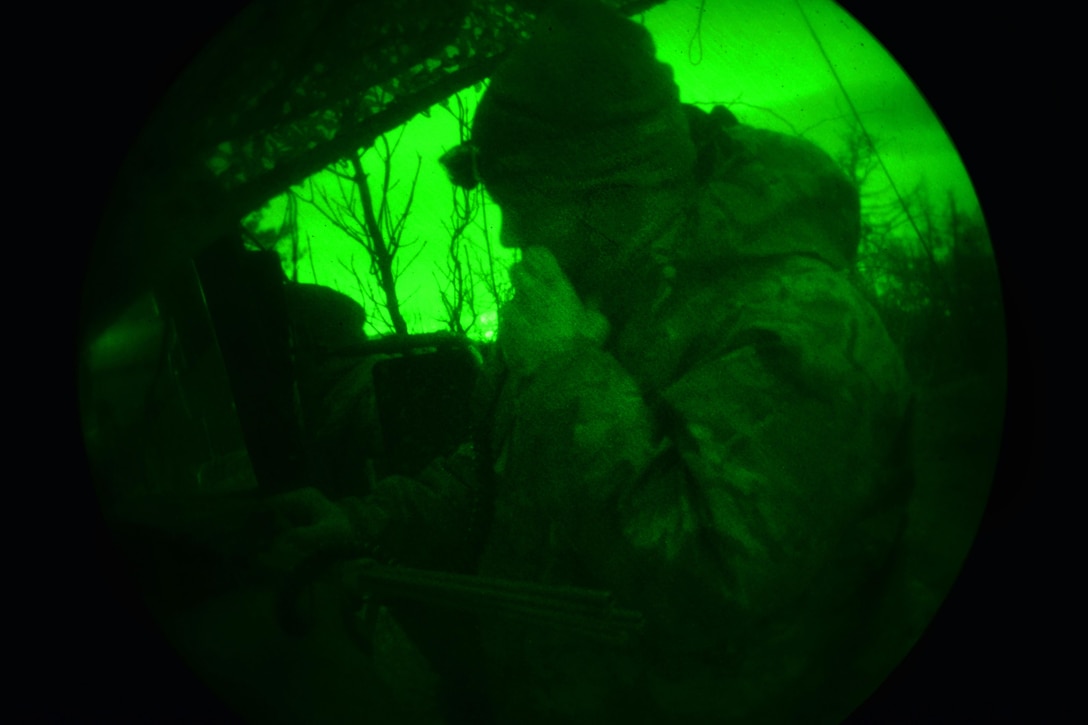 As seen through a night-vision device, an Army paratrooper conducts a radio check during a live-fire exercise as part of Exercise Rock Sokol at Pocek Range in Postojna, Slovenia, March 10, 2016. Army photo by Davide Dalla Massara