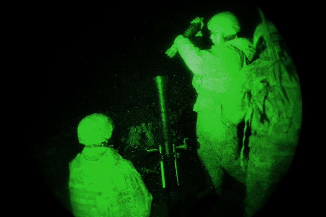As seen through a night-vision device, Army mortarmen load a 252A1 81 mm mortar system during a live-fire exercise as part of Exercise Rock Sokol at Pocek Range in Postojna, Slovenia, March 10, 2016. Army photo by Davide Dalla Massara