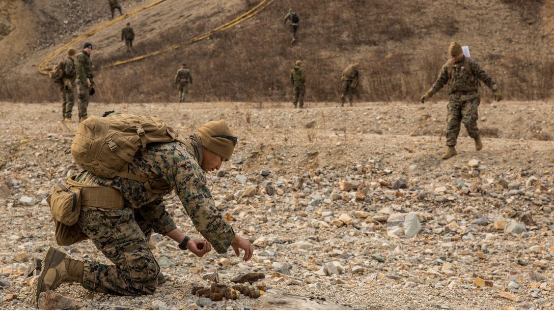 U.S. Marine explosive ordnance technicians with the 13th Marine Expeditionary Unit gather undetonated explosives in order to do a controlled detonation during Exercise Ssang Yong 16 on Suseongri live-fire range, Pohang, South Korea, March 13, 2016. Ssang Yong is a biennial combined amphibious exercise conducted by U.S. forces with the Republic of Korea Navy and Marine Corps, Australian Army and Royal New Zealand Army Forces in order to strengthen interoperability and working relationships across a wide range of military operations.