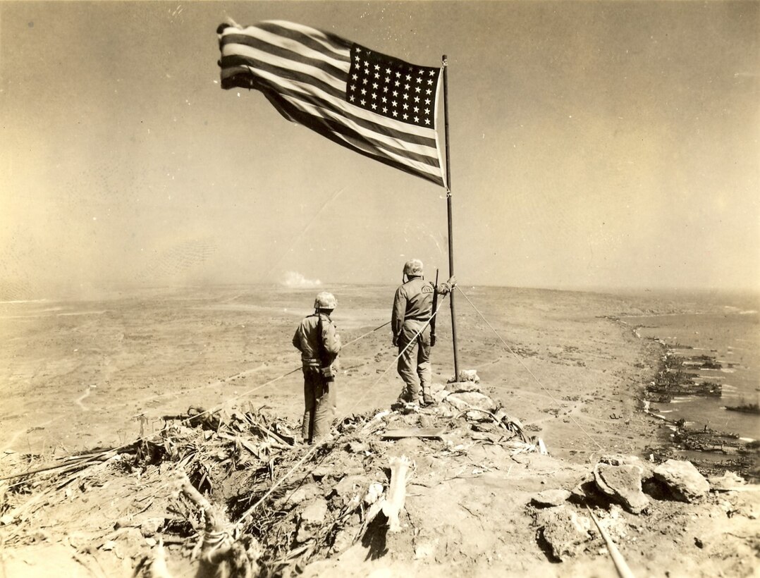 Iwo Jima, Japan, Feb-March 1945. Two Marines on Mount Suribachi watching the battle continue on the north end of the island. Reserve Marines served side-by-side with the Regulars and were indistinguishable throughout World War II.