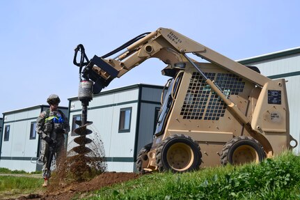 Spc. William Shaw (left) provides safety and ground guides Sgt. Timothy Marler, both with the 389th Engineer Company, while drilling post holes for a stairs project during Combat Support Training Exercise 78-16-01 at Fort Hunter Liggitt, Calif. Nearly 40 units from the U.S. Army Reserve, U.S. Air Force and Canadian Armed Forces trained at Joint Base McGuire-Dix-Lakehurst, N.J., Fort Knox, Ky. and Fort Hunter Liggett, Calif., as part of the 84th Training Command's CSTX 78-16-01. This exercise marks the first CSTX of 2016 and is hosted by the 78th Training Division. (U.S. Army photo by Sgt. Steffanie Collazo)