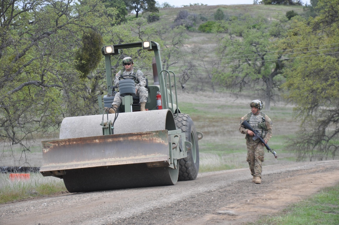 Spc. Richard Rodriguez from the 475th Engineer Company out of Ponce, Puerto Rico, conducts construction operations of a road as Sgt. Norbert Prats performs security during the Combat Support Training Exercise at Fort Hunter Liggitt, Calif. Nearly 40 units from the U.S. Army Reserve, U.S. Air Force and Canadian Armed Forces trained at Joint Base McGuire-Dix-Lakehurst, N.J., Fort Knox, Ky. and Fort Hunter Liggett, Calif., as part of the 84th Training Command's CSTX 78-16-01. This exercise marks the first CSTX of 2016 and is hosted by the 78th Training Division. (U.S. Army photo by Pvt. Brian Wentworth)