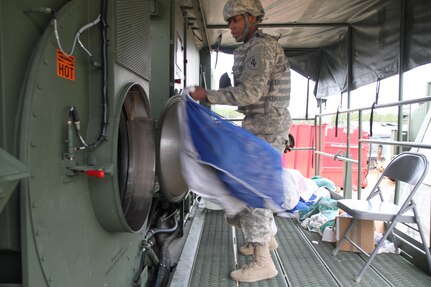 U.S. Army Spc. Devon Branscumb, a shower/laundry and clothing repair specialist assigned to the 1008th Quartermaster Company, operates a Laundry Advanced System (LADS) to wash Soldiers’ laundry in support of the Combat Support Training Exercise (CSTX) “Arctic Lightning” at Joint Base McGuire-Dix-Lakehurst, N.J., March 13, 2016. The 1008th Quartermaster Company supports other units participating in the 21-day exercise by providing fresh laundry and hot showers at the various training sites.