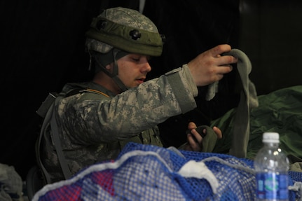 U.S. Army Spc. Joseph Roberson, a shower/laundry and clothing repair specialist assigned to the 1008th Quartermaster Company, folds clothes in support of the Combat Support Training Exercise (CSTX) “Arctic Lightning” at Joint Base McGuire-Dix-Lakehurst, N.J., March 13, 2016. The 1008th Quartermaster Company supports other units participating in the 21-day exercise by providing fresh laundry and hot showers at the various training sites.