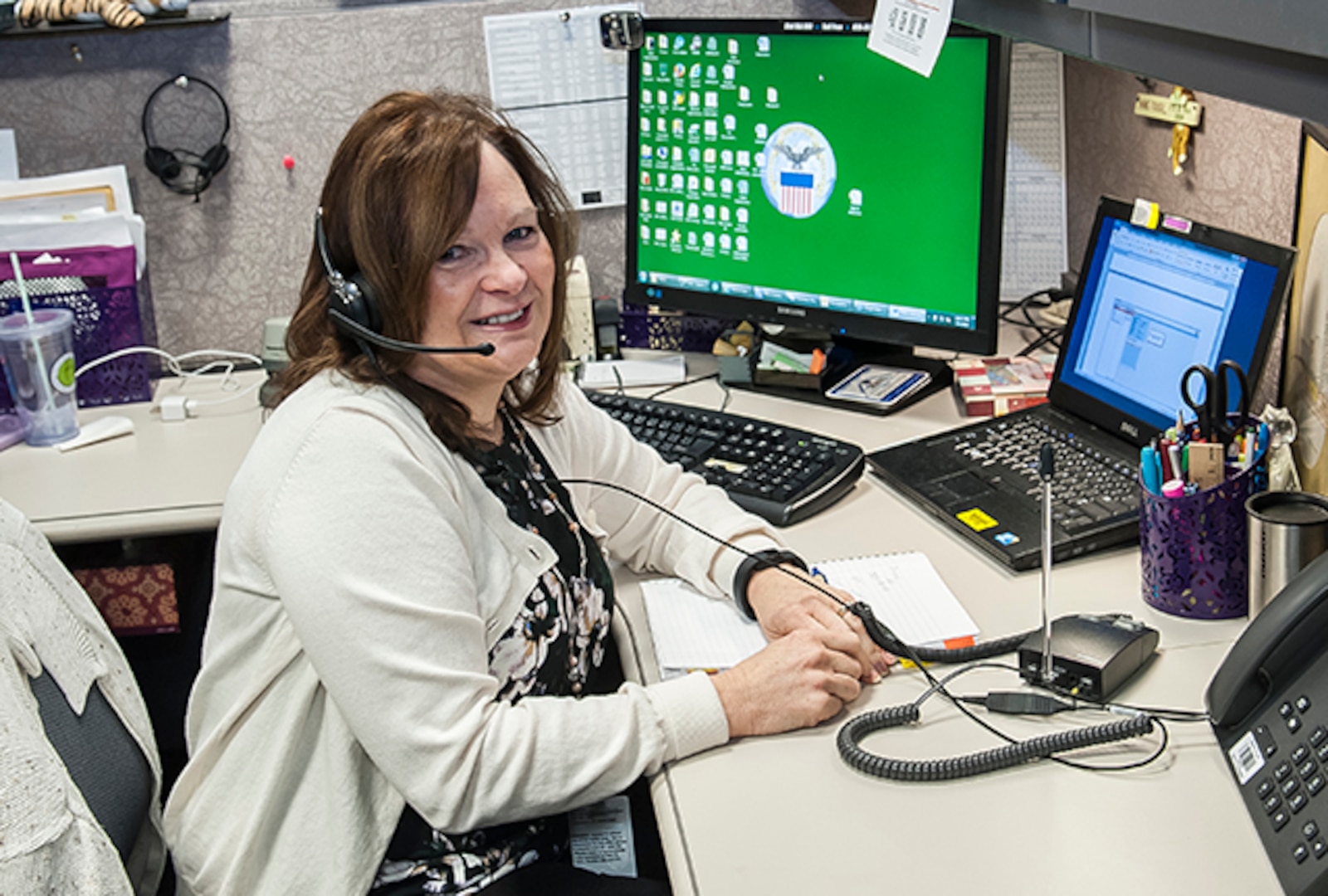 Jamie Carnevale works a customer systems issue while staffing the LTC help desk. Carnevale is part of an eight person team that works in Land and Maritime’s Systems Branch.
