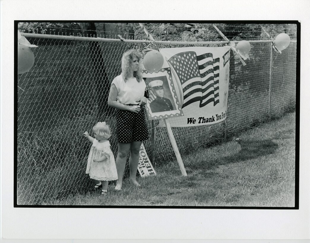 14th Marine Regiment, 1991. A wife and daughter of a Reserve Marine await his arrival at a Home Training Center after a deployment for the Gulf War.