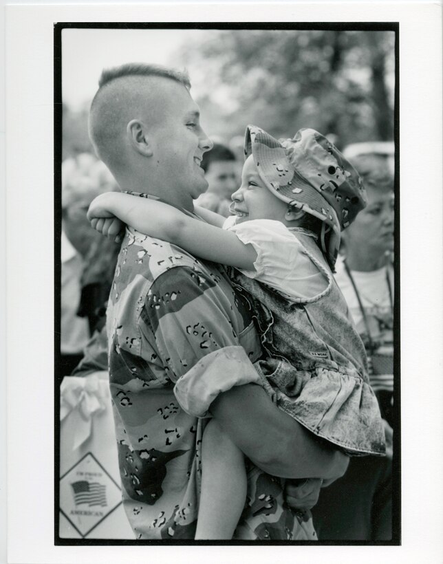 14th Marine Regiment, 1991. A father and daughter reunite at a unit homecoming celebration.