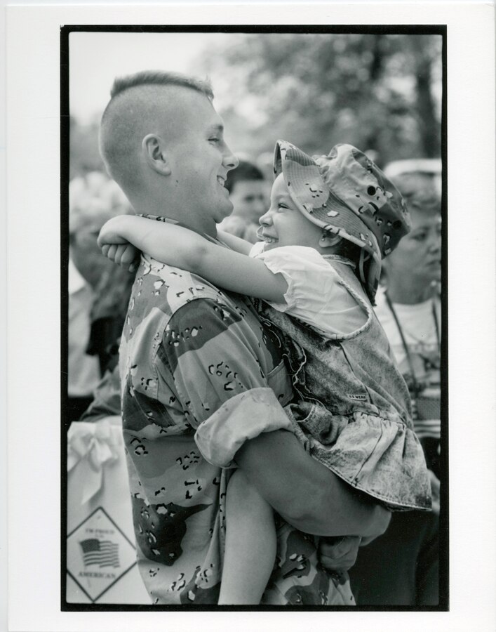 14th Marine Regiment, 1991. A father and daughter reunite at a unit homecoming celebration.