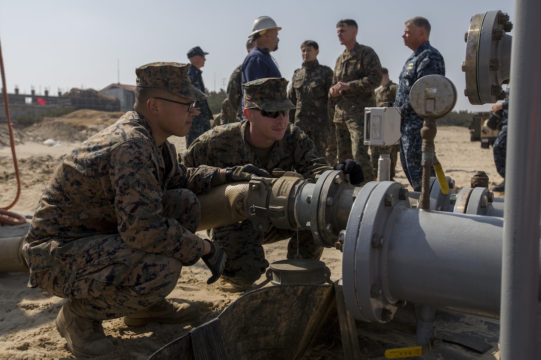 Marines monitor the flow rate of a beach termination unit from the USNS Vadm K .R. Wheeler during Exercise Ssang Yong 16 on Dogu Beach, South Korea, March 15, 2016. The Wheeler is equipped with an Offshore Petroleum Distribution System that transfers fuel from a tanker to depots ashore from up to eight miles off the coast. It simulated pumping fuel to Ssang Yong 16 ground forces by running sea water through its systems to storage tanks. Ssang Yong is a biennial military exercise focused on strengthening the amphibious landing capabilities of South Korea, the U.S., New Zealand and Australia. Marine Corps photo by Lance Cpl. Juan C. Bustos