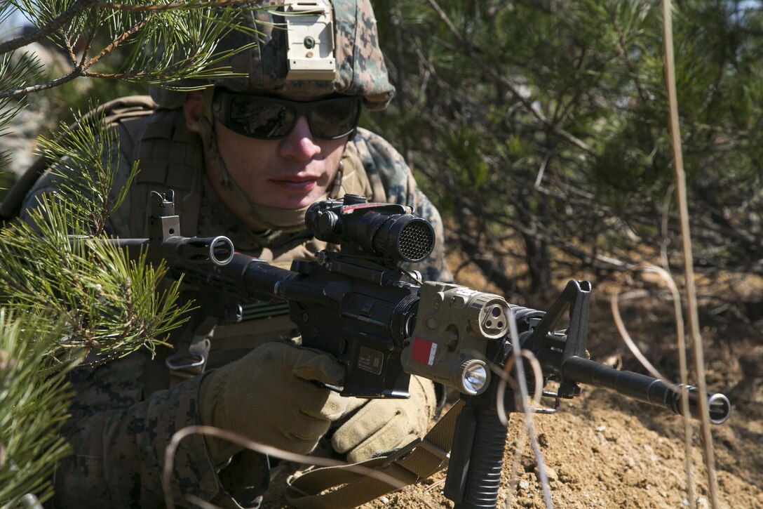 Marine Corps Cpl. Anthony May provides security while his unit prepares defensive positions during Exercise Ssang Yong 2016 in Pohang, South Korea, March 11, 2016. Marine Corps photo by Sgt. Briauna Birl