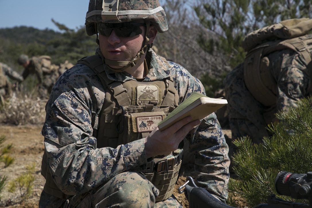 Marine Corps Cpl. Scott Songer relays grid coordinates during exercise Ssang Yong in Pohang, South Korea, March 11, 2016. Marine Corps photo by Sgt. Briauna Birl