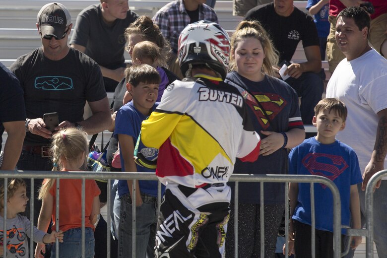 A freestyle motocross rider with Metal Mulisha greets fans at the Motocross Jam Fest aboard the Combat Center March 12, 2016. The event, hosted by Marine Corps Community Services, included concession stands, motorcycle stunt performances by professional motocross riders, and live rock music from Boston-based band, Lansdowne. (Official Marine Corps photo by Lance Cpl. Levi Schultz/Released)