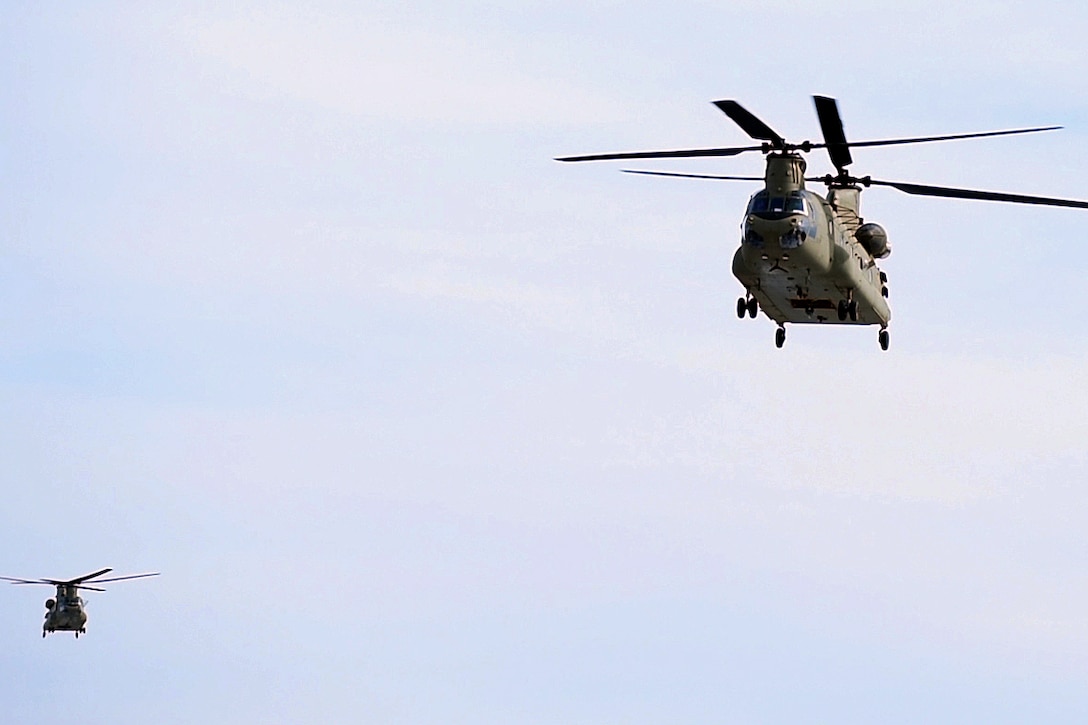 Two CH-47F Chinook helicopters approach a landing zone during joint urban training on Fort Drum, N.Y., March 5, 2016. The helicopter crews are assigned to the New York Army National Guard's Company B, 3rd Battalion, 126th Aviation Regiment. Airmen assigned to the New York Air National Guard's 274th Air Support Operations Squadron also participated in the training. New York National Guard photo by Air Force Master Sgt. Eric Miller