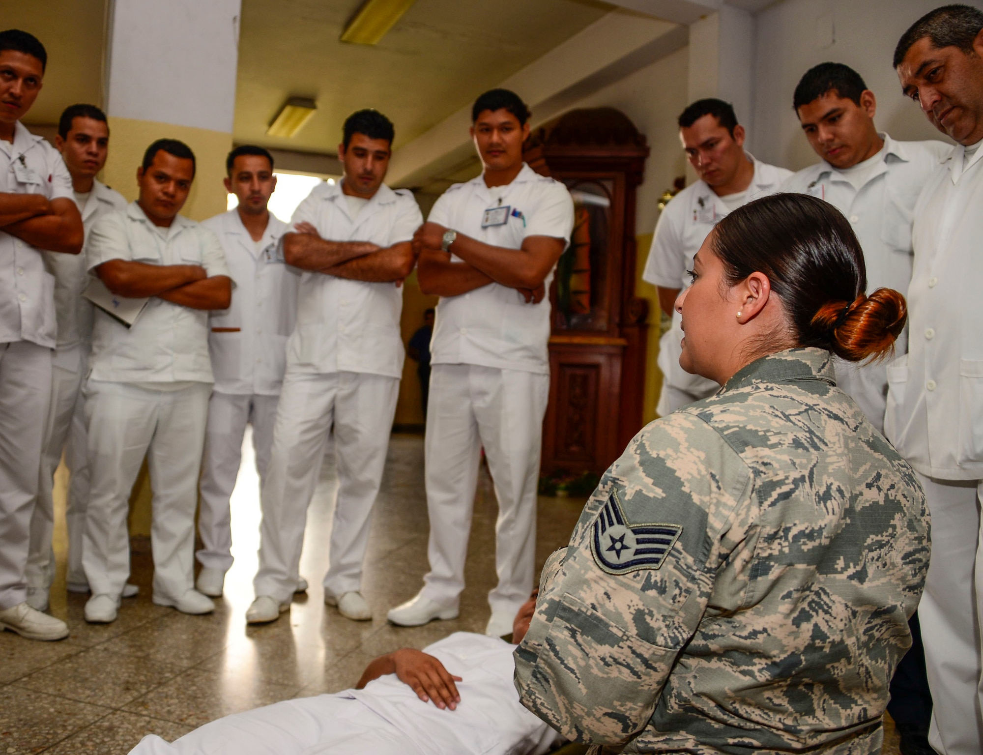 U.S. Air Force Staff Sgt. Karina Cortes, a medical technician stationed at Joint Base Charleston, S.C., briefs to medical technicians in training on litter carry techniques at Hospital Militar de El Salvador during a medical subject matter expert exchange in San Salvador, El Salvador, March 11, 2016. Earlier in the week, Carey led a team of Air Force medical professionals in a week-long exchange with Salvadoran medics at Ilopango Air Base.  After the subject matter expert exchange was completed, the team was invited to a share their expertise with members of the Hospital Militar de El Salvador.  (U.S. Air Force photo by Tech. Sgt. Heather R. Redman/Released)