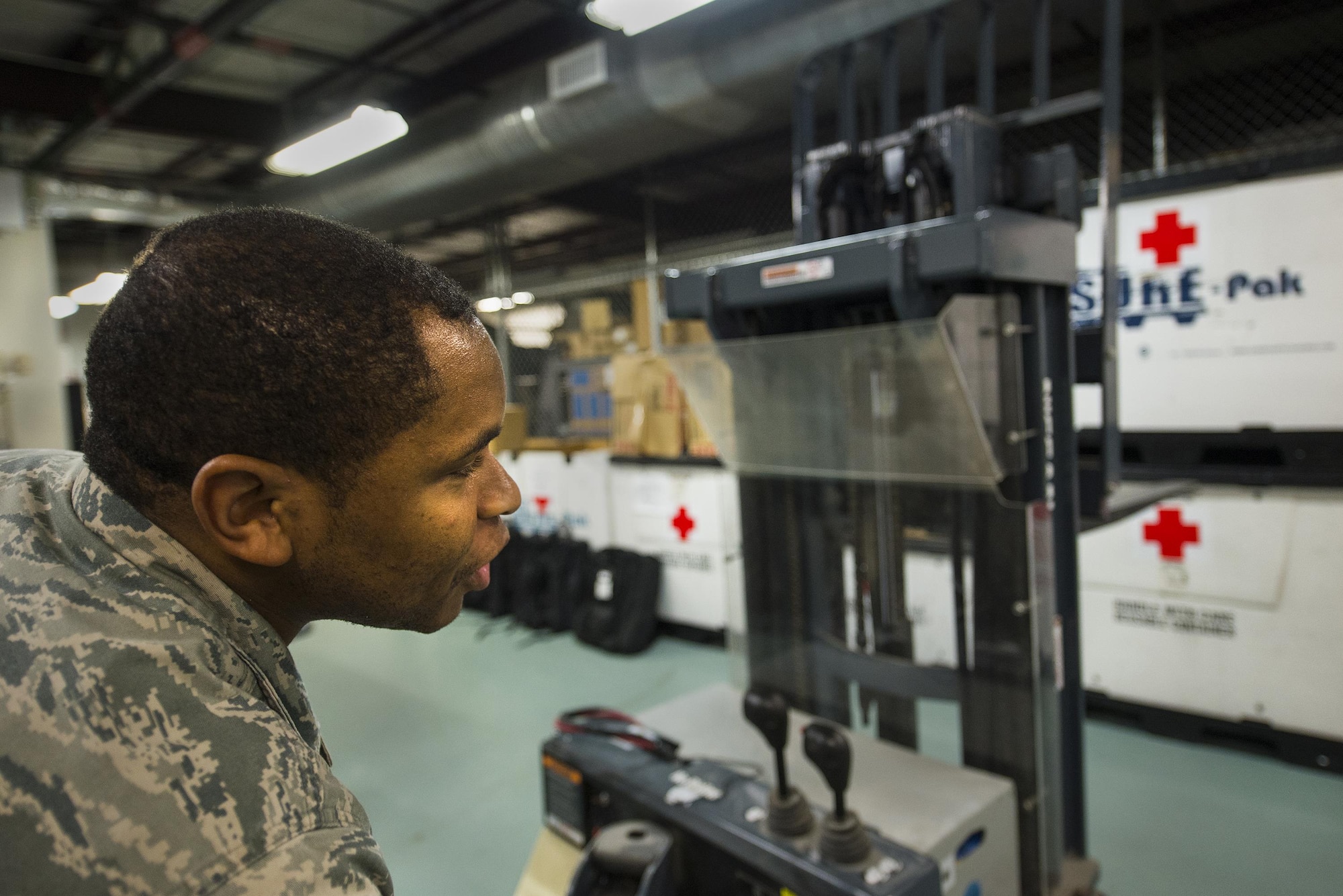 U.S. Air Force Staff Sgt. Mark Bell, 23d Medical Support Squadron NCO in charge of logistics, ensures a forklift is lined up correctly, March 15, 2016, at Moody Air Force Base, Ga. Medical logistics personnel support the 23d Wing, its tenant units and geographically separated units.  (U.S. Air Force photo by Airman Daniel Snider/Released)
