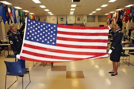 Sgt. 1st Class Irv Rowe and 1st Lt. Dominique Davidson, both assigned to the
U.S. Army Reserve's 7-80th Transportation Battalion out of Fort Eutsis, Virginia, practice folding the Flag during Military Funeral Honors Training March 15.