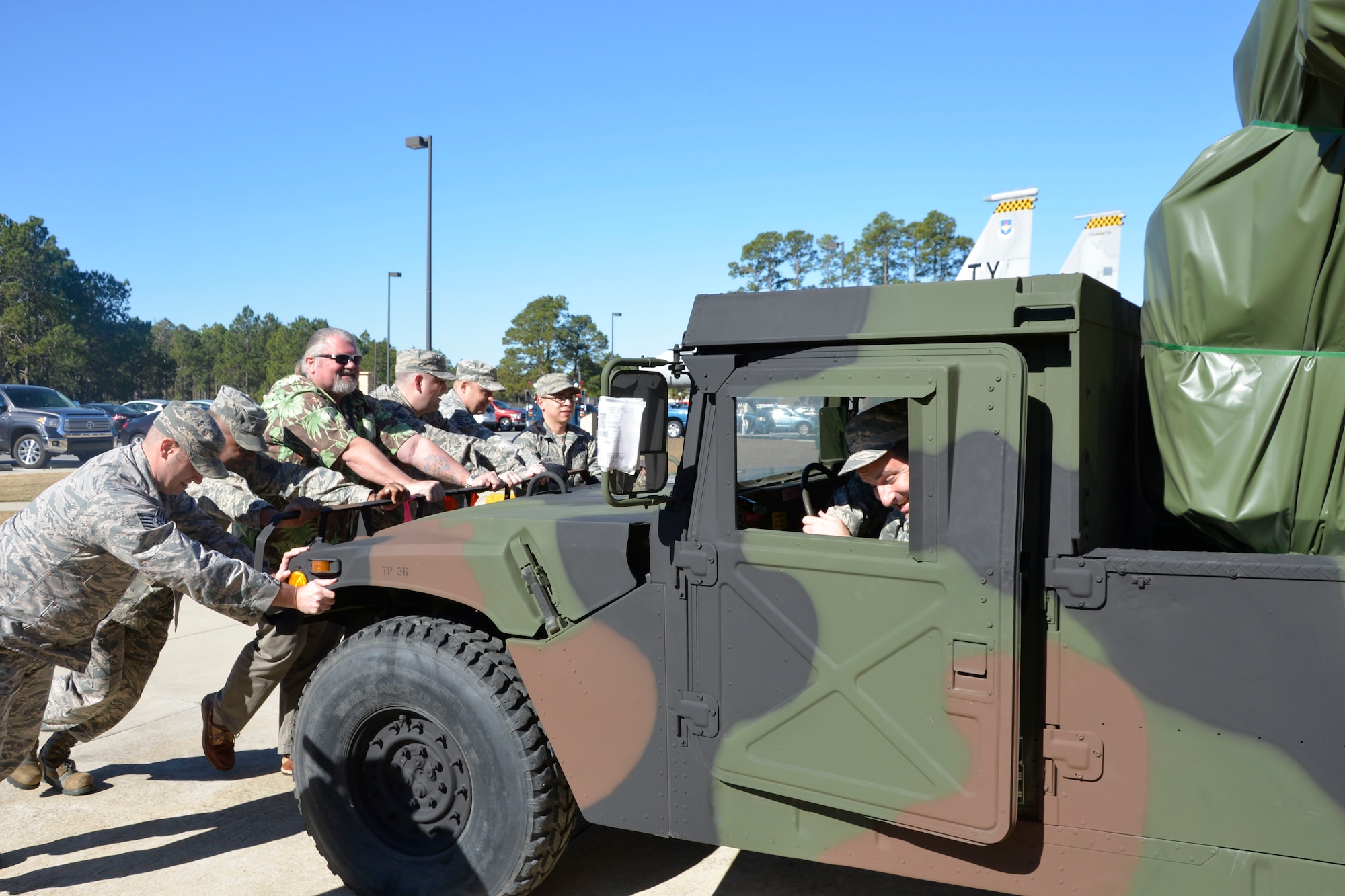 From the driver’s seat, Chief Master Sgt. Curtis Bates, Air Forces Northern  Logistics Directorate,  checks the direction as the  Avenger Air  Defense System is pushed toward its display spot in front of the Killey Center for Homeland Operations Feb. 18. 