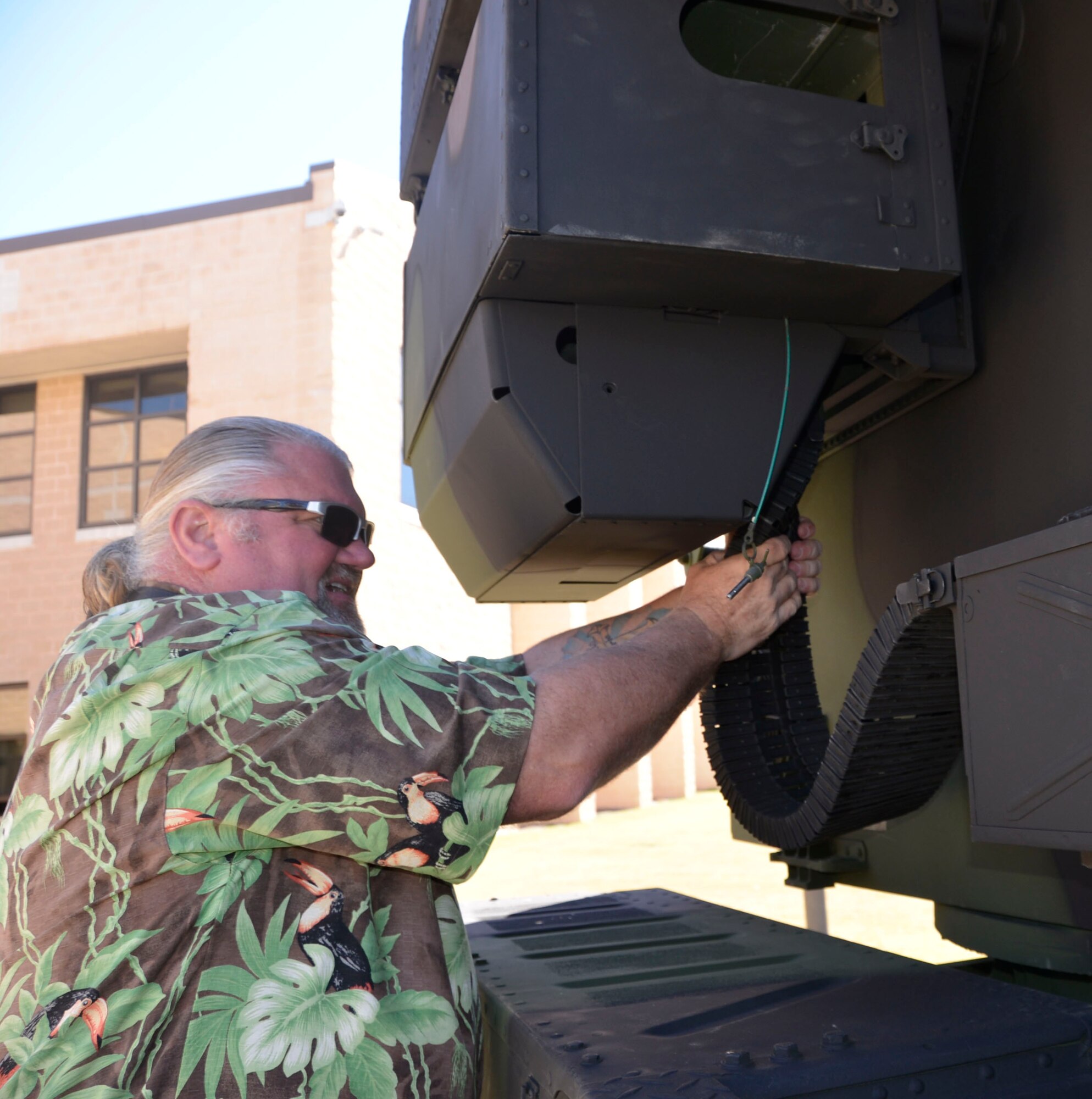 Christopher Batastini, Air Forces Northern  Logistics Directorate, hooks up the gun conveyor belt on the Avenger Air -Defense System’s .50 caliber M3P machine gun. 