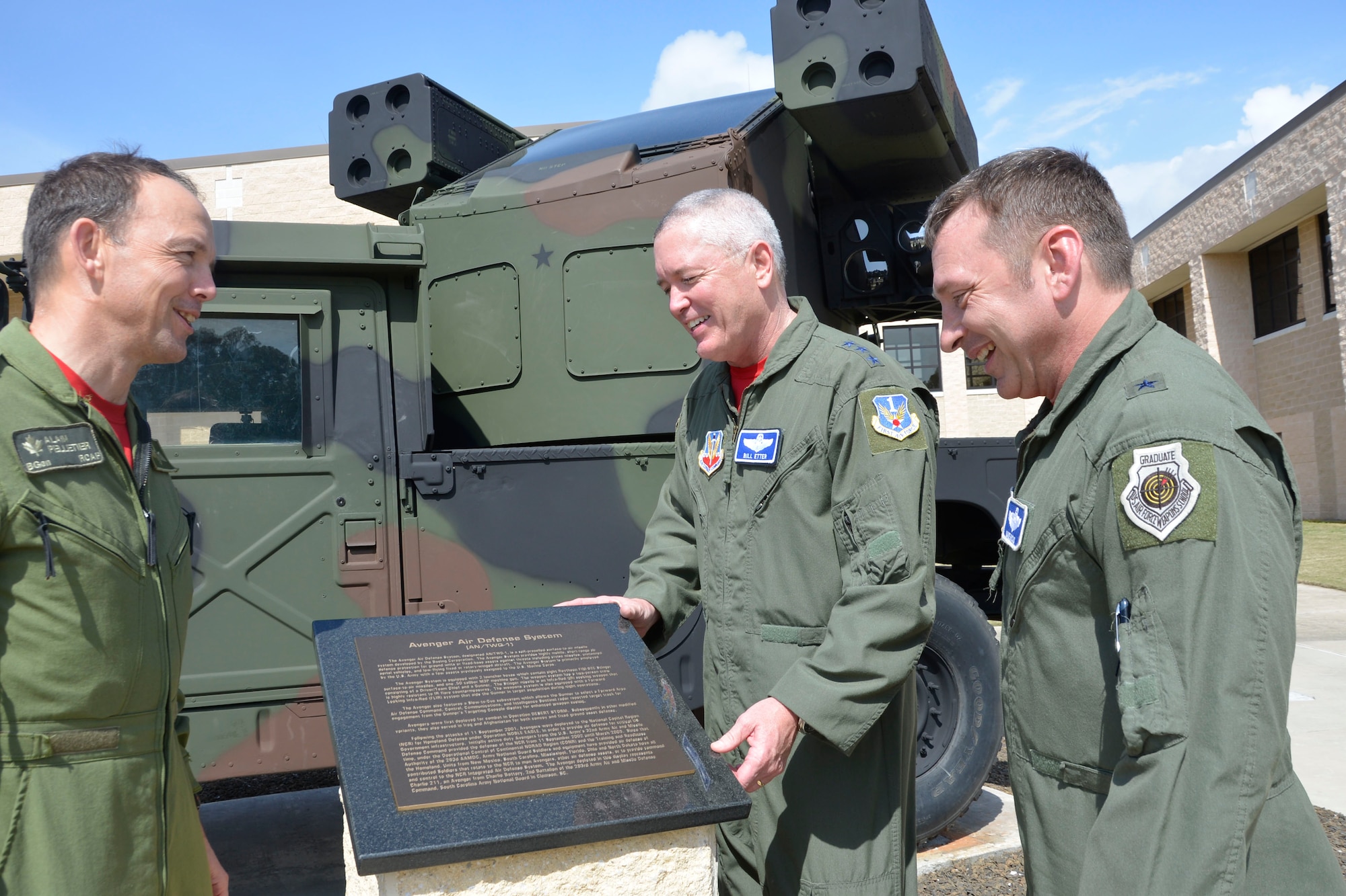BGen. Alain Pelletier, Deputy Commander, Continental North American Aerospace Defense Region,  Lt. Gen. William Etter, Commander, Continental North American Aerospace Defense Region-1st Air Force (Air Forces Northern) and Brig. Gen. David Hicks, Vice Commander, 1st Air Forces Northern, look over the commemorative plaque of the Avenger Air -Defense System that arrived at the Killey Center for Homeland Operations Feb. 18.  