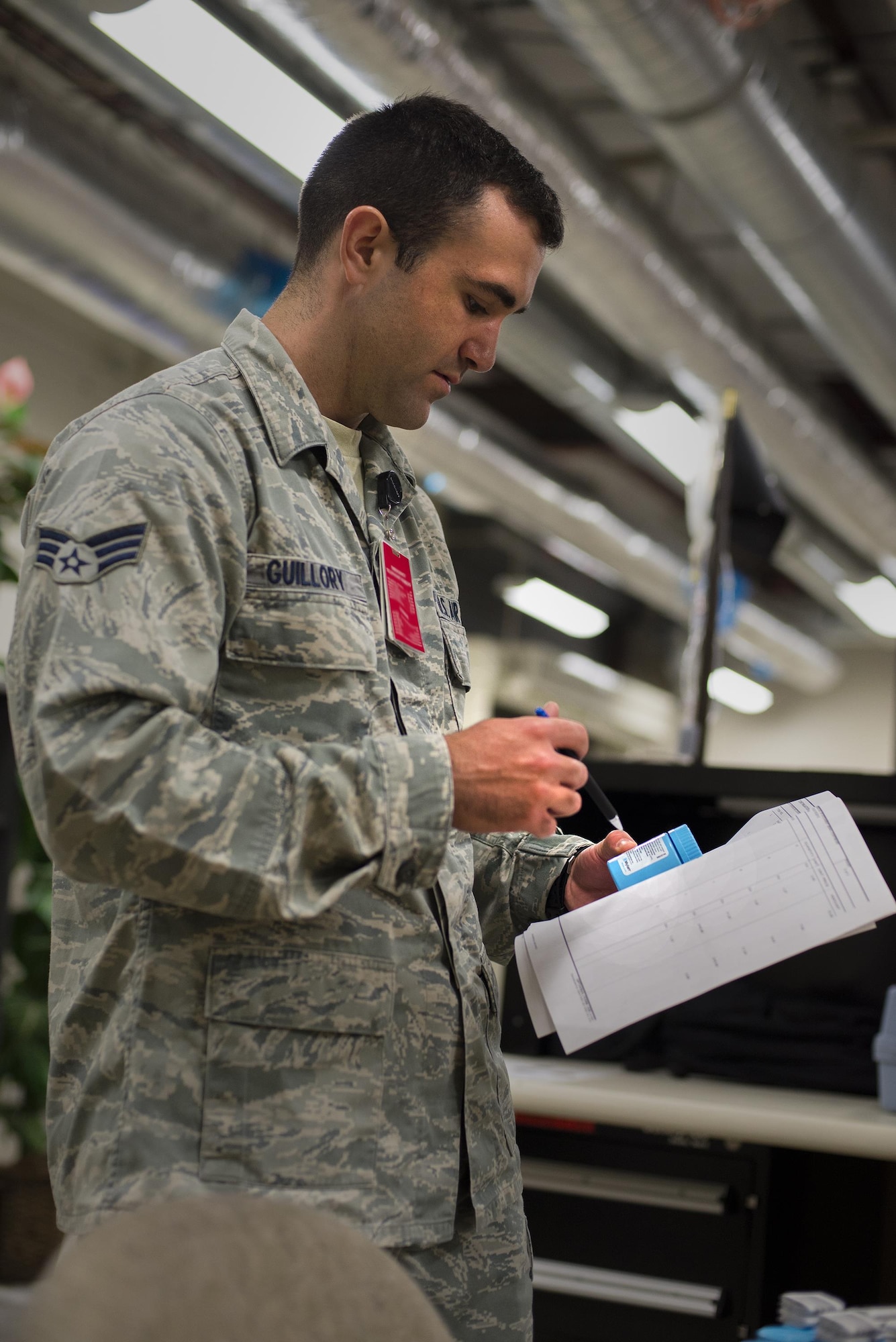 U.S. Air Force Senior Airman Tray Guillory, 23d Medical Support Squadron logistics customer service representative, checks an order form, March 15, 2016, at Moody Air Force Base, Ga. The medical logistics team inspects and repacks first-aid kits to equip deployed Airmen with life-saving essentials. (U.S. Air Force photo by Airman Daniel Snider/Released)