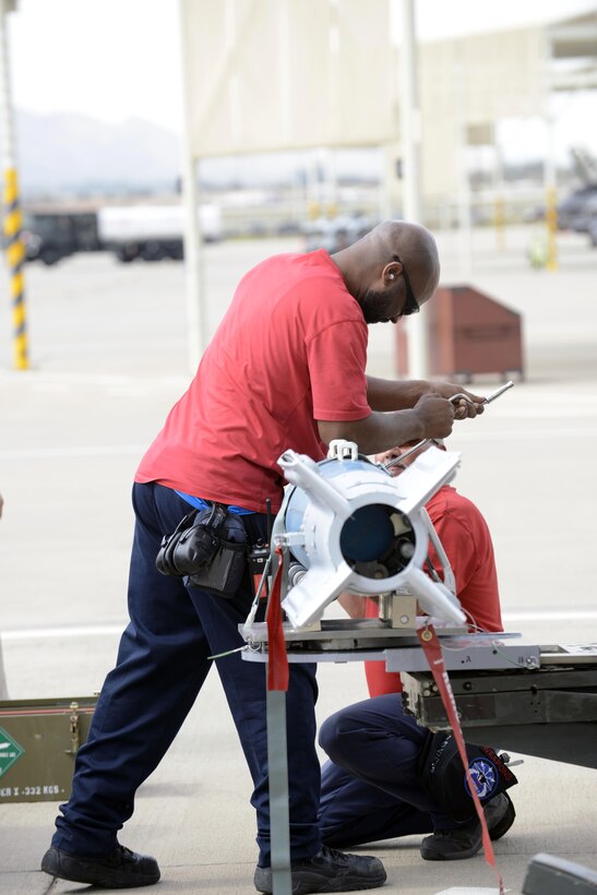 Weapons load crew members from the 62nd Aircraft Maintenance Unit prepare to load laser-guided bombs onto an F-35 Lightening II March 11, 2016, at Luke Air Force Base, Ariz. The F-35 Lightning II program took another step toward initial operational capability yesterday when two aircraft assigned to the 62nd Fighter Squadron successfully employed four laser guided bombs on the Barry M. Goldwater Range. The maintenance load crew team was comprised of Lockheed Martin contractors. (U.S. Air Force Photo by Senior Airman Devante Williams)
