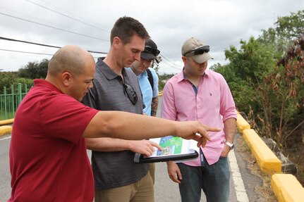 81st Civil Affairs team member evaluate a bridge near Salinas, Puerto during Operation Coqui in order to identify any potential flooding or other issues that could arise during a disaster such as a hurricane. 