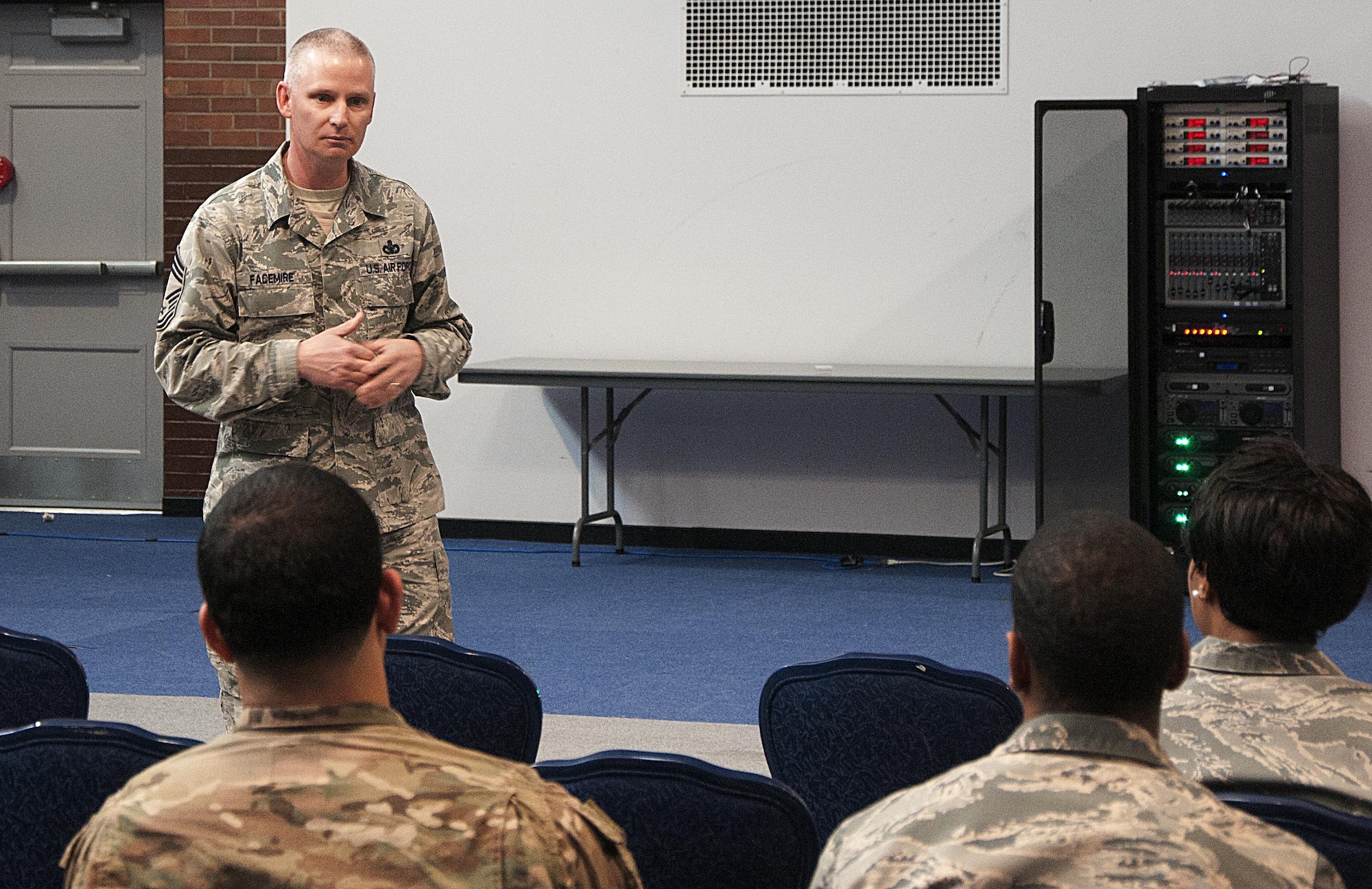 Chief Master Sgt. John Facemire, 90th Mission Support Group superintendent, speaks to a group of Airmen March 16, 2016, during a Developmental Special Duty job fair in the Fall Hall Community Center on F.E. Warren Air Force Base, Wyo. The fair, hosted by the Warren Lead 5/6 organization, allowed Airmen to speak with base personnel who have had experience with different special duties. (U.S. Air Force photo by Senior Airman Brandon Valle)