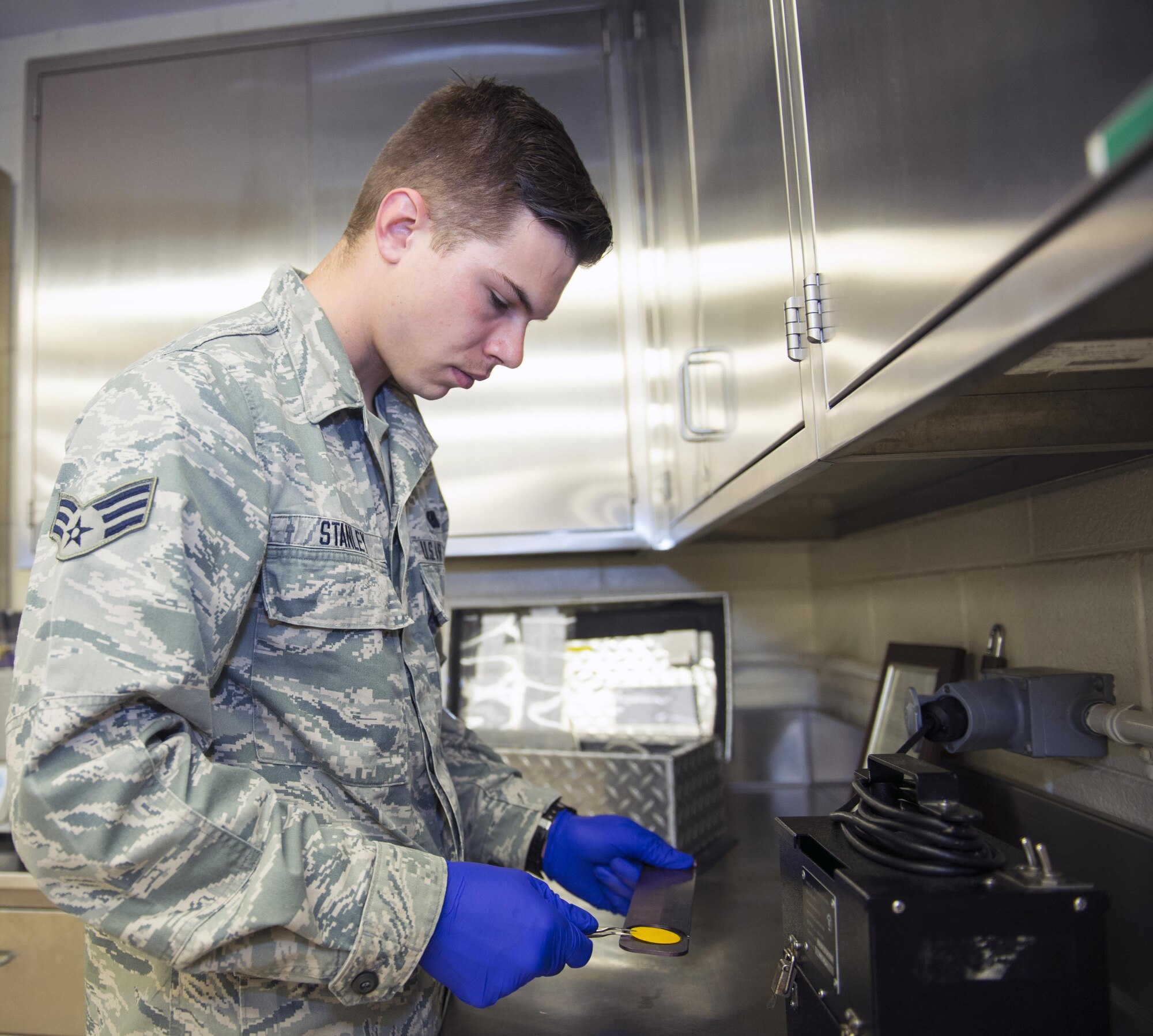 U.S. Air Force Senior Airman Zachary Stanley, 23d Logistics Readiness Squadron fuels laboratory technician, uses a free-water detector during sample testing, March 16, 2016, at Moody Air Force Base, Ga. The detector is used to reveal unacceptable amounts of free water in fuel which may indicate faulty water eliminating equipment. (U.S. Air Force photo by Airman 1st Class Greg Nash/Released)