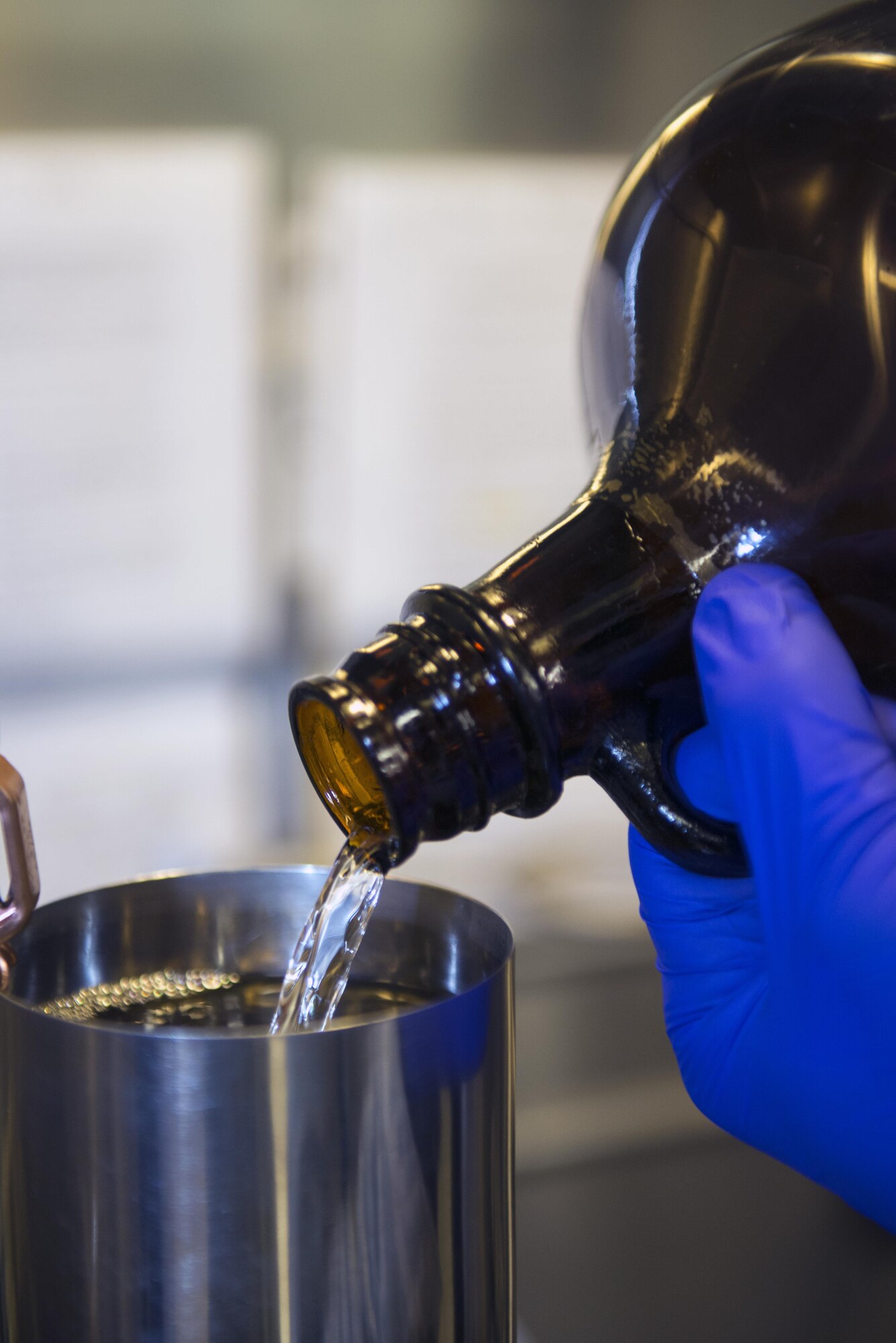 U.S. Air Force Senior Airman Zachary Stanley, 23d Logistics Readiness Squadron fuels laboratory technician, pours jet fuel into a flask during fuels sample testing, March 16, 2016, at Moody Air Force Base, Ga. The fuels management flight contributed to approximately 10,000 refuels on Moody’s HC-130J Combat Kings, A-10C Thunderbolt II’s, and HH-60G Pave Hawks within the last fiscal year. (U.S. Air Force photo by Airman 1st Class Greg Nash/Released)