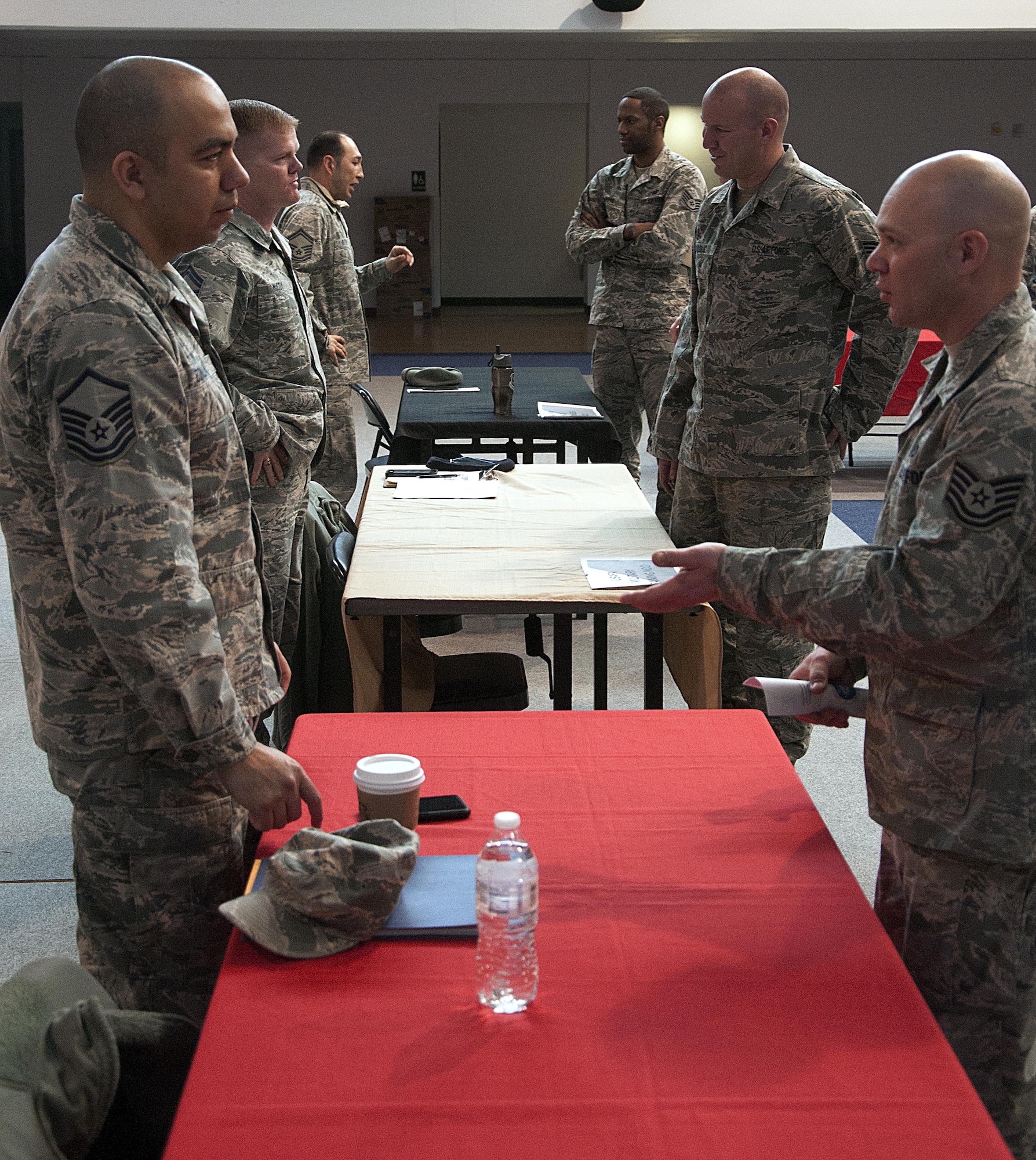 Master Sgt. Alexandro Bonilla, 90th Force Support Squadron career assistance advisor; Master Sgt. Brady McCoy, 790th Missile Squadron; and Senior Master Sgt. David Rivera, 90th FSS Airman and Family Readiness Center readiness NCO, speak with Airmen March 16, 2016, during a Developmental Special Duty job fair in the Fall Hall Community Center on F.E. Warren Air Force Base, Wyo. Each sergeant had experience in a different special duty, which helped them answer questions from Airmen. (U.S. Air Force photo by Senior Airman Brandon Valle)