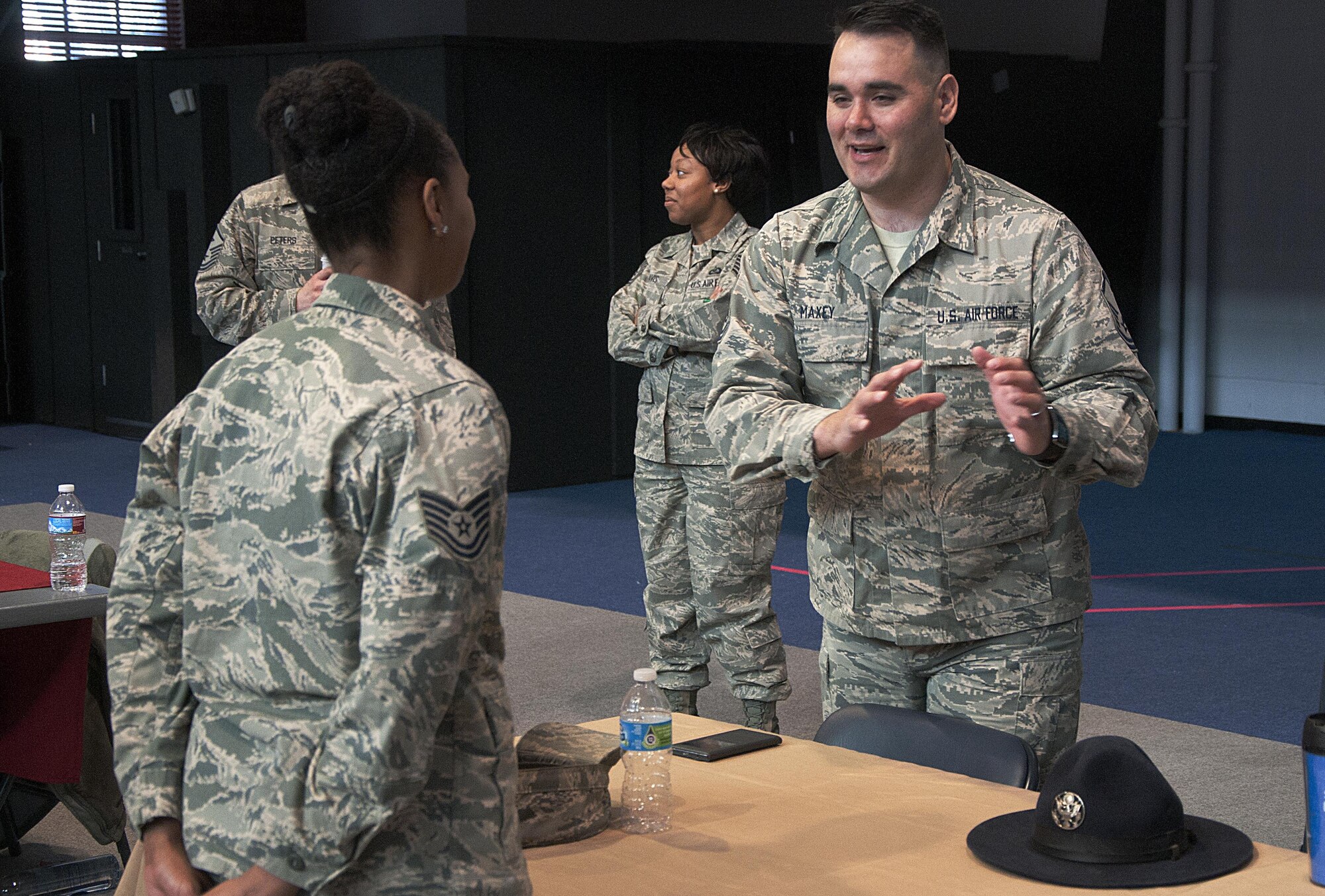 Master Sgt. Royal Maxey, 90th Missile Security Forces, speaks with a technical sergeant about his past experiences as a military training instructor during a Developmental Special Duty job fair in the Fall Hall Community Center on F.E. Warren Air Force Base, Wyo., March 16, 2016. Airmen were invited out to the Fall Hall Community Center to learn about the different career opportunities available outside of their current career fields. (U.S. Air Force photo by Senior Airman Brandon Valle)