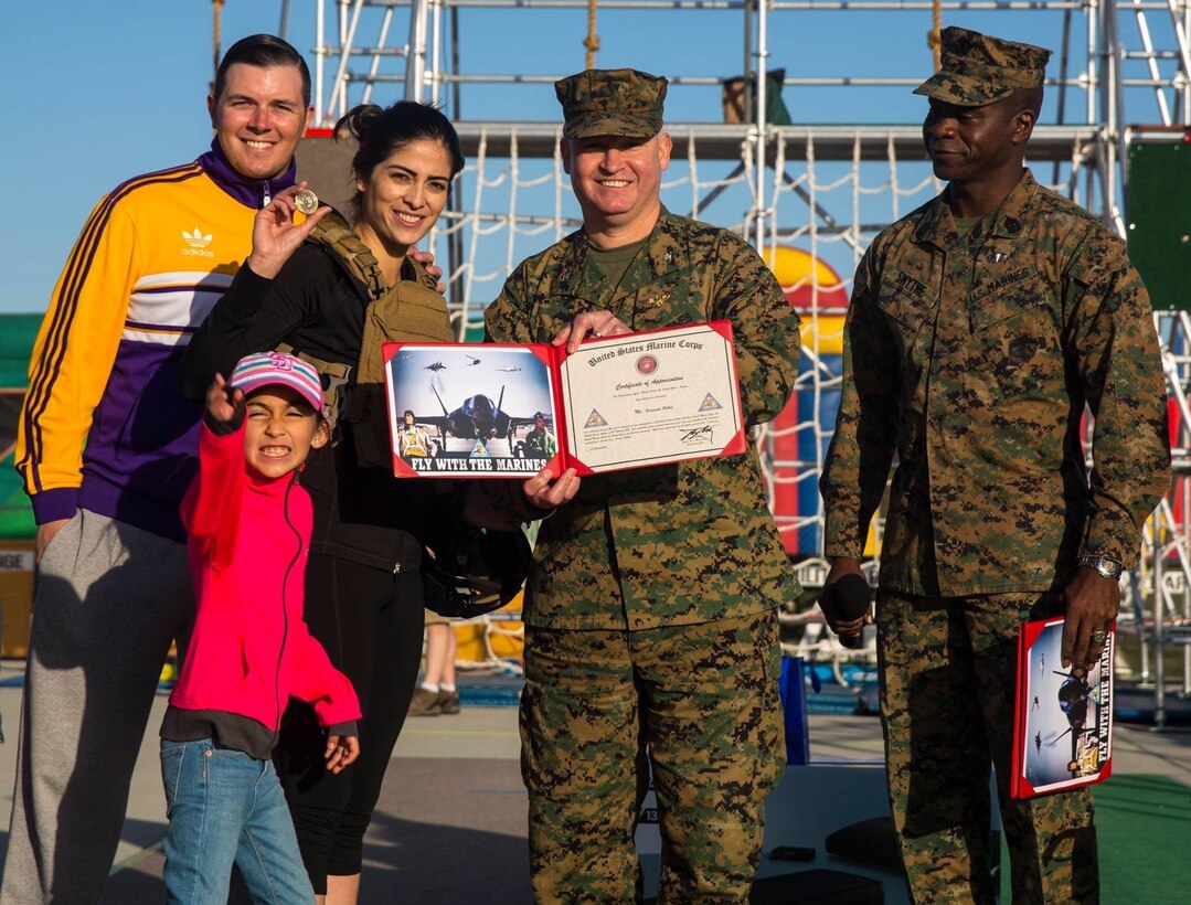As part of the Yuma Patriot Festival, Telemundo’s Fernanda Robles participates in the Marine Corps Battle Challenge and is awarded by station commanding officer Col. Ricardo Martinez and station Sgt. Maj. Delvin Smythe, at Marine Corps Air Station Yuma, Ariz., Saturday, Feb. 27, 2016.