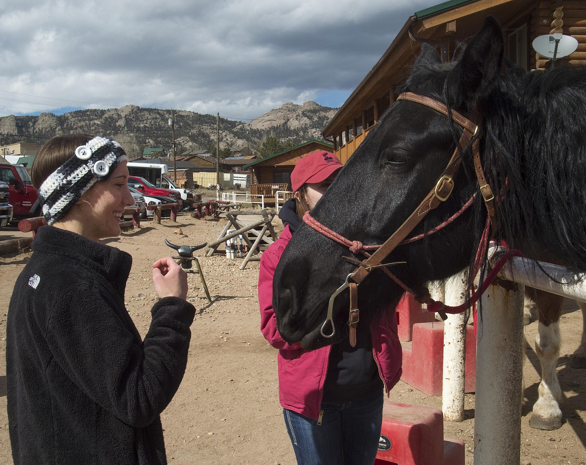 Brittany Lee and 1st Lt. Lindsey Byrd, 321st Missile Squadron, visit with Tracy the horse March 13, 2016, before the start of their trail ride in Estes Park, Colo. Lee and Byrd had made the trip down from F.E. Warren Air Force Base, Wyo., as part of a trip sponsored by the base’s outdoor recreation office. (U.S. Air Force photo by R.J. Oriez)