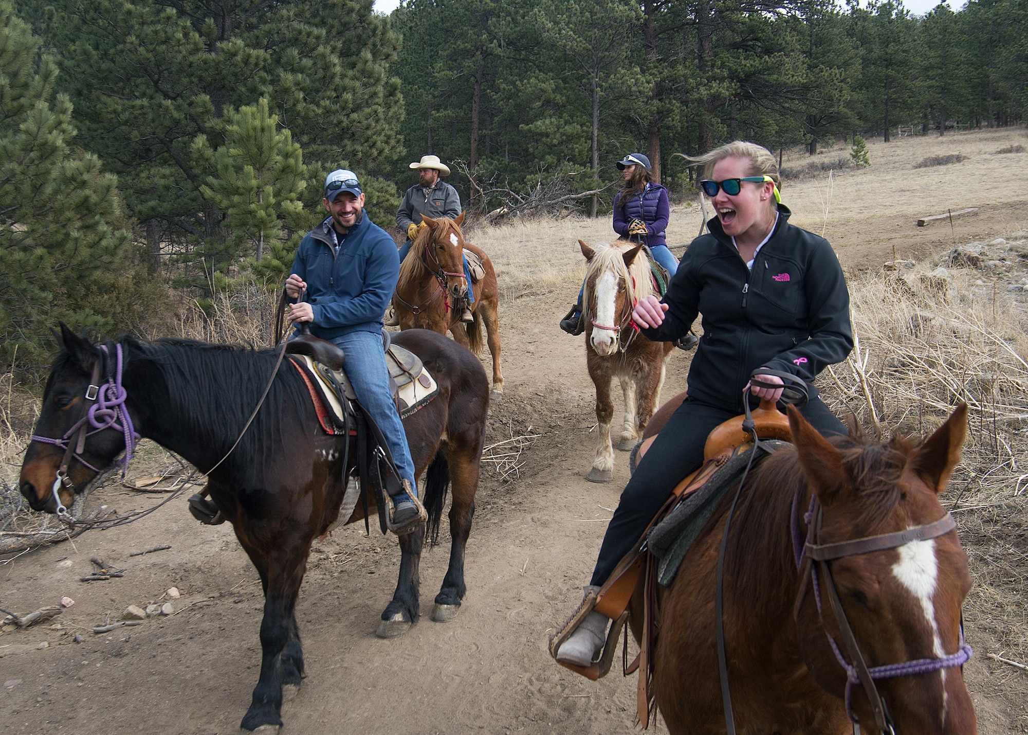Senior Airman Rachel Silverberg and Joe Harvey, both with the 90th Force Support Squadron, share a laugh during a trail ride outside of Estes Park, Colo., March 13, 2016. Harvey served as trip leader for F.E. Warren Air Force Base Outdoor Recreation-sponsored group of Airmen, retirees and dependents. (U.S. Air Force photo by R.J. Oriez)