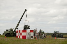 Naval Mobile Construction Battalion 3 Seabees and 18th Civil Engineer Squadron barrier maintenance Airmen lift a BAK-12 aircraft arresting system out of a barrier shack on the flight line Feb. 29, 2016, at Kadena Air Base, Japan. Rodriguez and members of U.S. Every ten years, engineer teams perform an overhaul and replacement of the entire aircraft barrier arresting system, worth approximately $328,000. (U.S. Air Force photo by Senior Airman Peter Reft)