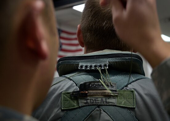 U.S. Air Force Senior Airman Danny Lo, an Aircrew Flight Equipment journeyman with the 35th Operation Support Squadron, tailors a life preserver to Capt. Miklos Preysz, the bravo flight commander with the 14th Fighter Squadron, at Misawa Air Base, Japan, March 8, 2016. Each piece of equipment is specifically tailored to every pilot to maximize comfort and operational use. The life preserver serves as a flotation device if the pilot crashes or is ejected in an area around water. (U.S. Air Force photo by Senior Airman Deana Heitzman)