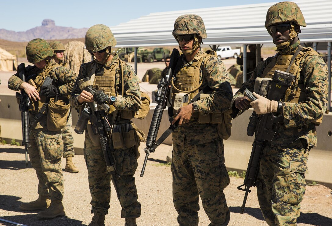 Marines with Marine Wing Support Squadron 371, based out of Marine Corps Air Station Yuma, load magazines in preparation for shooting drills with their M16A4 service rifles during a squadron field exercise at the U.S. Army Yuma Proving Ground training facility in Yuma, Ariz., Wednesday, March 9, 2016.
