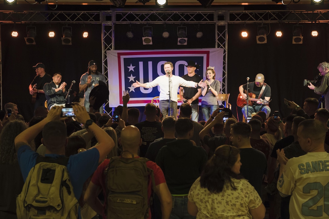 Country music artist and army veteran Craig Morgan, Miss America 2016 Betty Cantrell and UFC fighter Donald "Cowboy" Cerrone share the stage as they perform for troops and family members at a USO spring tour show on Camp Hansen, Japan, March 13, 2016. DoD photo by Army Staff Sgt. Sean K. Harp