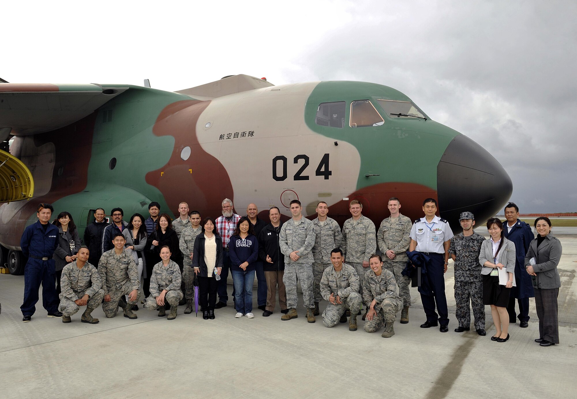 Members from the 733rd Air Mobility Squadron and Japan Air Self Defense Force pose for group photo in front of a JASDF C-1 cargo jet during a tour, March 10, 2016, at Naha Air Base, Japan. 733rd AMS Airmen performed an exchange with JASDF members to tour operations at Aerial Port to foster better communication, understanding, and friendship between the U.S. Air Force and JASDF partners. (U.S. Air Force photo by Naoto Anazawa)
