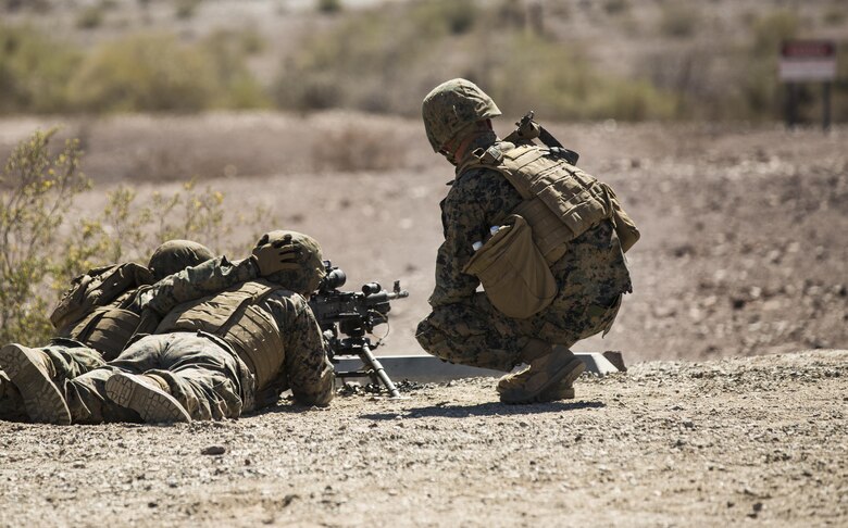 Marines with Marine Wing Support Squadron 371 (MWSS-371), based out of Marine Corps Air Station Yuma, fire an M249 Squad Automatic Weapon (SAW), during a squadron field exercise at the U.S. Army Yuma Proving Ground training facility in Yuma, Ariz., Wednesday, March 9, 2016.
