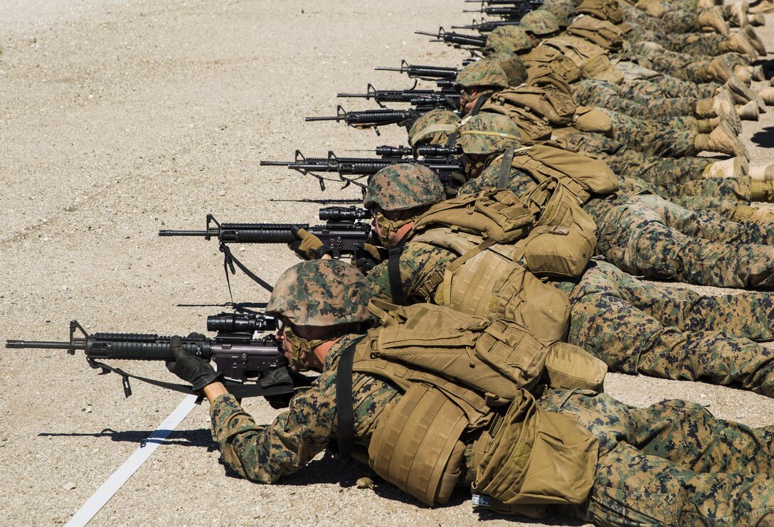 Marines with Marine Wing Support Squadron 371 (MWSS-371), based out of Marine Corps Air Station Yuma, perform shooting drills with their M16A4 service rifles during a squadron field exercise at the U.S. Army Yuma Proving Ground training facility in Yuma, Ariz., Wednesday, March 9, 2016.