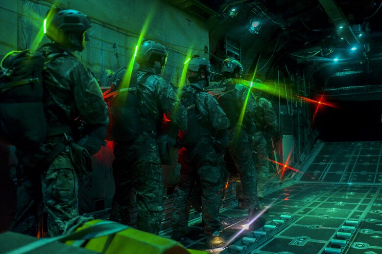 SERE (Survival Evasion Resistance Escape) specialists wait before preforming static line jumps as the door of a C-130, assigned to Dobbins Air Reserve Base, opens over the Nevada Test and Training Range, March 11, 2016. SERE specialists lead the AF emergency parachuting program and conduct extensive testing of parachuting systems. They are uniquely suited to analyze the operating environment to plan for evasion, captivity, and recovery considerations. (U.S. Air Force photo by Airman 1st Class Kevin Tanenbaum)  