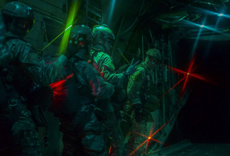 SERE (Survival Evasion Resistance Escape) specialists signal how long before preforming static line jumps out of a C-130 assigned to Dobbins Air Reserve Base opens over the Nevada Test and Training Range, March 11, 2016. SERE specialists build foreign partner relationships, preparing the environment for potential future isolation and enabling flexible recovery options even in the absence of significant American military presence. (U.S. Air Force photo by Airman 1st Class Kevin Tanenbaum)  