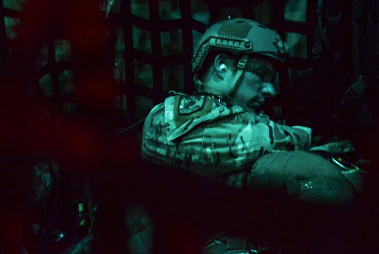 A SERE (Survival Evasion Resistance Escape) specialist rests before making a static line jump out of a C-130, assigned to Dobbins Air Reserve Base, Georgia, over the Nevada Test and Training Range, March 11, 2016. Provide state of the art preparation, planning, execution, and adaptation of Personnel Recovery to combatant commanders across the full spectrum of operations by applying Survival, Evasion, Resistance and Escape tactics, techniques, and procedures to enable isolated personnel to "Return With Honor." (U.S. Air Force photo by Airman 1st Class Kevin Tanenbaum)  