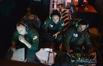 Crew members aboard an HC-130 Hercules airplane from Air Station Barbers Point monitor surveillance equipment for suspected of drug trafficking in the Eastern Pacific, Jan. 25, 2016. Military patrol aircraft search for drug traffickers around the clock in an attempt to reduce illegal drug activity in the region. 