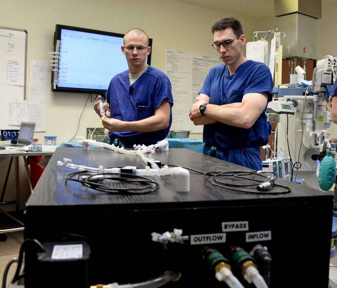Maj. Timothy Williams, left, and Maj. Lucas Neff, right, perform bench top testing of balloon catheters March 14 at Travis Air Force Base, Calif., using a custom-made blood flow simulator. The CIF, located at David Grant USAF Medical Center, is the research facility where the REBOA catheter came to fruition. (U.S. Air Force photo by Senior Airman Amber Carter)
