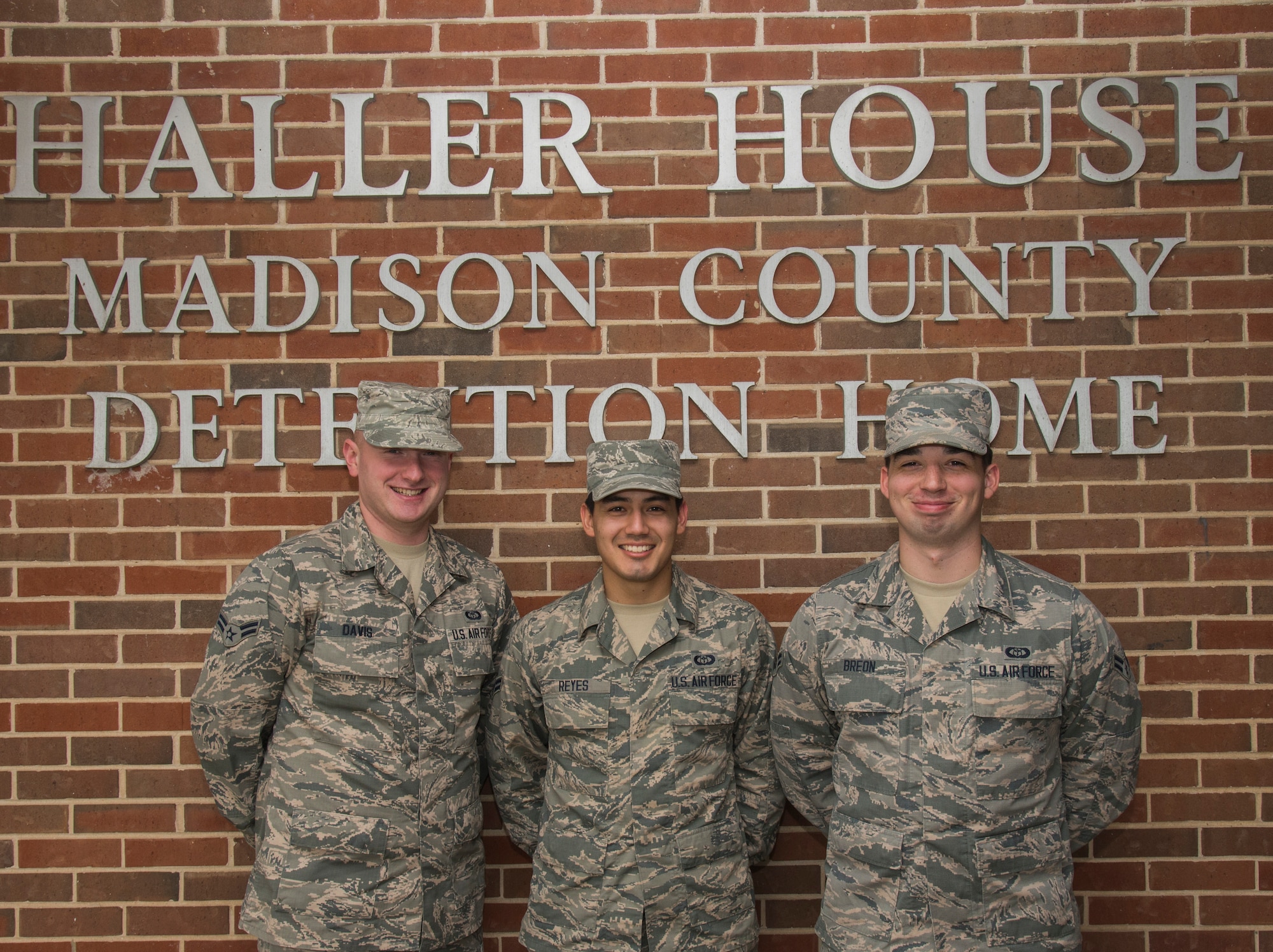 Airman First Classes George Davis, Jonathon A. Reyes, and John Breon pose for a photo before receiving a tour of the Madison County Detention Home Mar. 10 in Edwardsville, Illinois. The home is a 21 bed facility utilized as the County’s temporary placement center for juveniles awaiting court decisions for their cases. (U.S. Air Force photo/Airman Daniel Garcia)