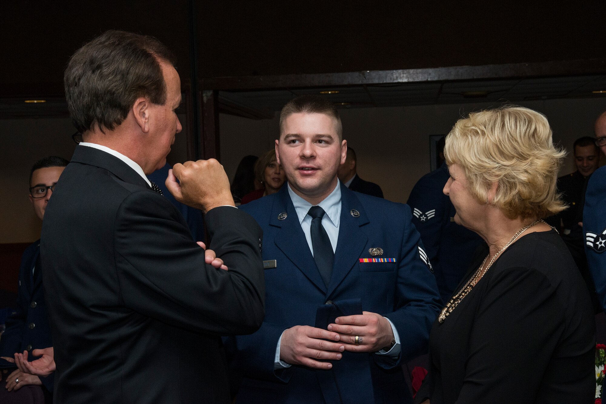 Belle-Scott civilian Phil Hickman, President, Southern Illinois/ St. Louis Metro East Market at Associated Bank, and his wife Mary talk to Senior Airman Joshua Bennett, 375 CSPTS at the Belle-Scott dinner March 10, 2015.(U.S. Air Force Photo by Airman Daniel Garcia)