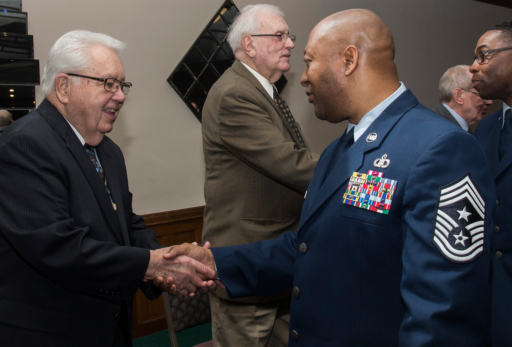 Chief Master Sgt. Wes Mathias, 375th Air Mobility Wing Command Chief, thanks WWII veteran Norman Becherer for his service. Becherer supported survivor recovery efforts at Mauthausen concentration camp during the war. (U.S. Air Force Photo by Airman Daniel Garcia)