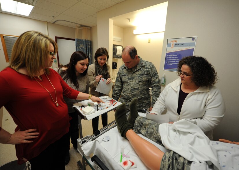 Members of the 319th Medical Group search for hazards in a ?Room of Horrors? March 16, 2016, on Grand Forks Air Force Base, North Dakota. The 319th MDG observed Patient Safety Awareness Week by training Airmen and patients on the importance of safety. (U.S. Air Force photo by Airman 1st Class Ryan Sparks/Released)